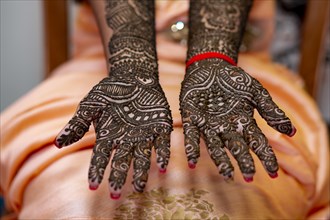 Hand of a Hindu bride painted with henna on the eve of her wedding in Beau-Bassin