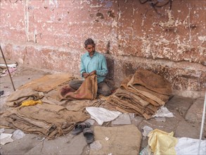 Worker sewing sacks