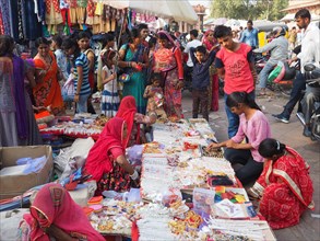 Vendors offering jewellery at a market stall