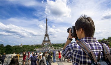 Tourist photographing Eiffel Tower