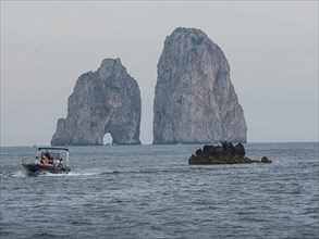 Boats in front of Faraglioni rock group