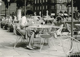 Bayreuth in 1963: a young woman sits on the terrace of a street cafe eating an ice cream