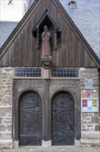 Wooden figure of John the Baptist above the portal of the Protestant St. John's Church in Wernigerode