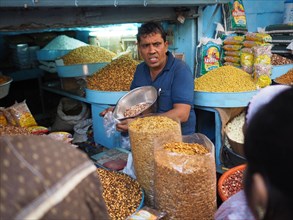 Vendor offers pulses at the market stall