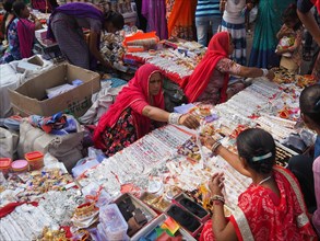 Vendors offering jewellery at a market stall
