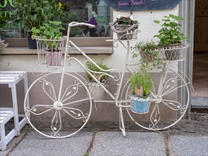 Bicycle as decoration in front of the shop gallery Clara in Quedlinburg