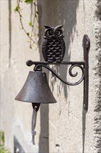 Bell on a wall in the shape of an owl