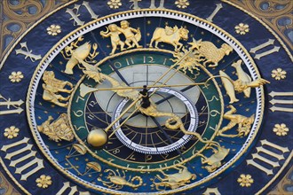 Richly decorated astronomical clock with signs of the zodiac at the town hall