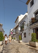 Two tourists in narrow streets of Altea Old Town