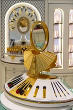 Golden mirror and make-up on a display