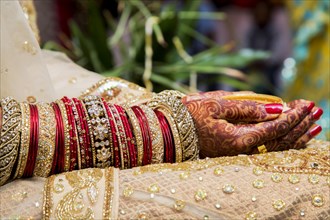 Traditional bridal jewelry and henna decoration on the hands of a bride during a religious ceremony at a Hindu wedding