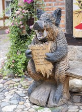 Wooden bear figure in front of the mustard shop in Quedlinburg