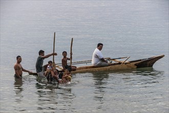 Loc boys having unin a canoe