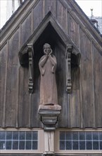 Wooden figure of John the Baptist above the portal of the Protestant St. John's Church in Wernigerode