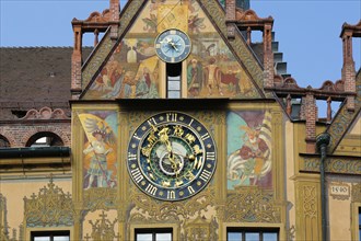 Richly decorated astronomical clock with signs of the zodiac on the town hall