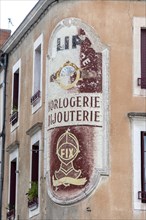 Saint-Pourcain sur Sioule. Advertisement painted on the facade of a house