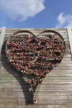Metal heart filled with love locks