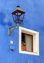 Close-up of streetlight and window of blue fishermen's house in Villajoyosa