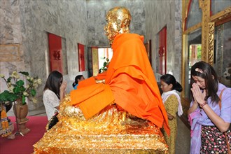 Gold leaf covered statue of Buddhist monk