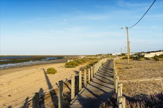 Wooden walkways with view on wetlands of Ria Formosa on Faro Beach Peninsula