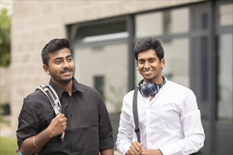 Students outside with bag in front of the university