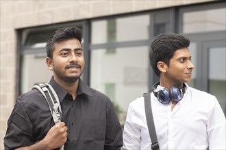Students outside with bag in front of the university