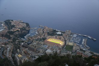 Illuminated sports stadium Stade Louis II in the Fontvieille district in front of a UEFA Champions League match of the football club AS Monaco