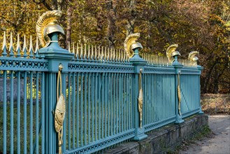 Restored fence with gold helmets at the Lake Grienerick obelisk in Rheinsberg