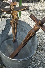 Two cruxifixes in zinc tub