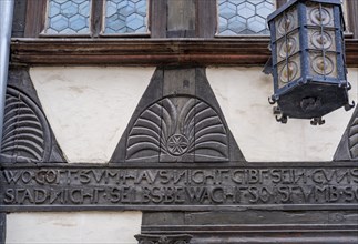 Writing on wooden beams on a burgher's house from 1569 in the Lower Saxon half-timbered style in the old town of Quedlinburg