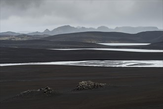 River and lakes in black lava desert