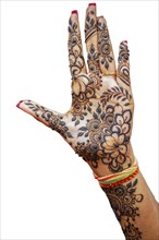 Hand of Hindu bride painted with hennas isolated on white background
