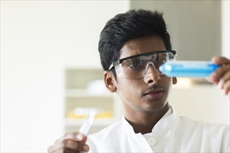 Student in an internship at the university with sample and lab coat