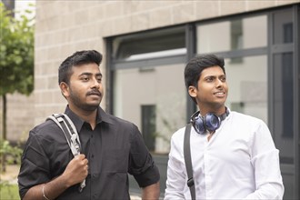 Students outside with bag in front of the university
