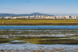 City of Faro seen from Faro Beach Peninsula with wetlands of Ria Formosa in between