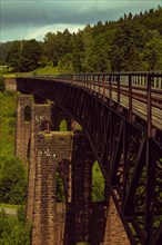Old stone railway viaduct in the mountains