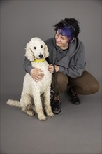 Woman with white king poodle
