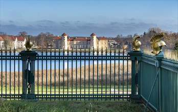 Restored fence with gold helmets at the Lake Grienerick obelisk in Rheinsberg