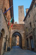 Ancient houses and family tower in old main street of San Gimignano
