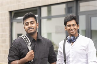 Students outside with bag in front of the university