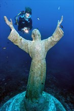 Diver looking at statue of Christ