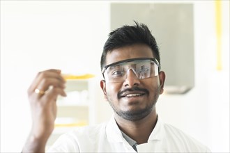 Student in an internship at the university with sample and lab coat