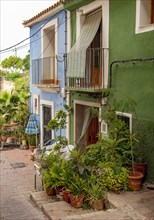 Close-up of colorful houses with flowerpots in Villajoyosa