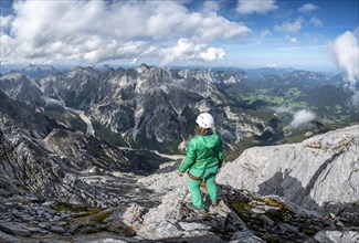 Hiker with helmet at the summit of the Watzmann