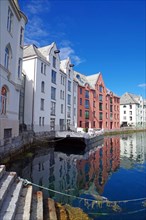 Stone houses reflected in a harbour basin