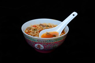 Asian noodle soup in bowl with Asian spoon