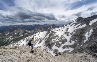 Hikers descending rocky terrain