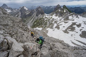 Hiker and hiker descending rocky terrain