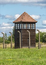 Barbed-wire fence and guard tower at Auschwitz II-Birkenau concentration camp
