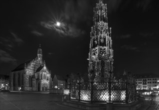 Beautiful fountain and Church of Our Lady at full moon